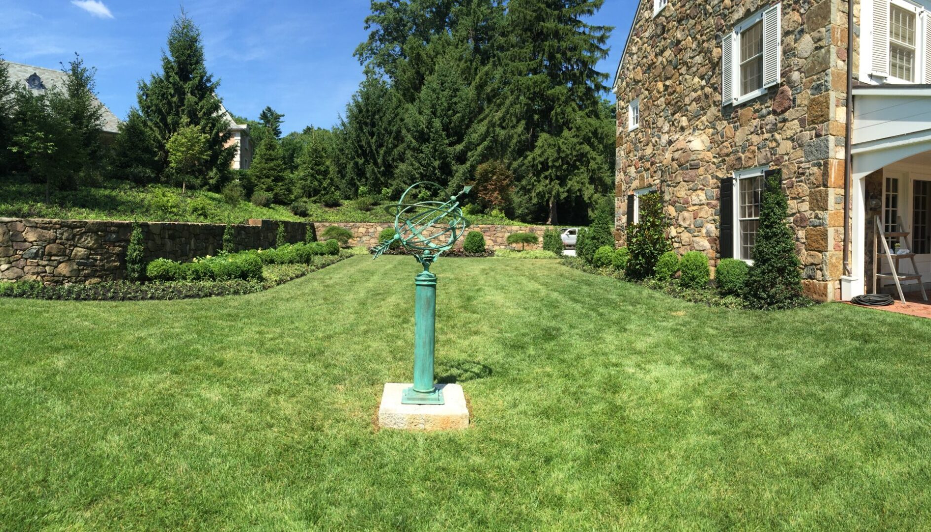 A green statue in the middle of a yard.