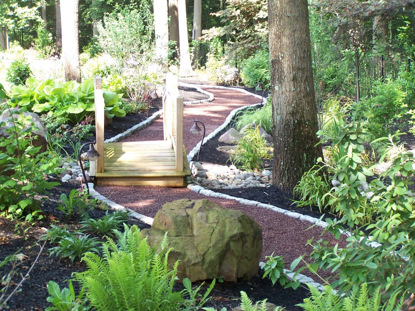 A garden path with steps leading to the top of the stairs.