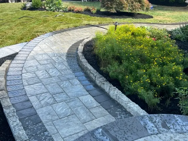 Curved marble pathway surrounded with bushes