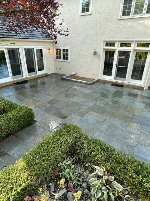 Walkway in front side of a house with flagstones