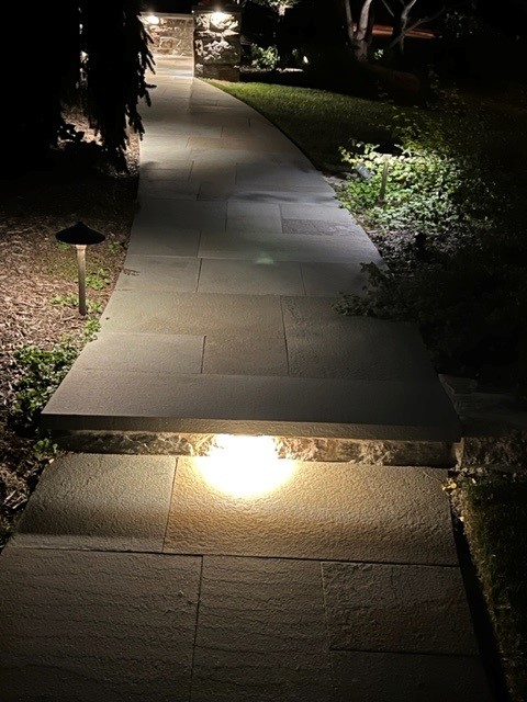 Light shining under the pathway made of flagstones