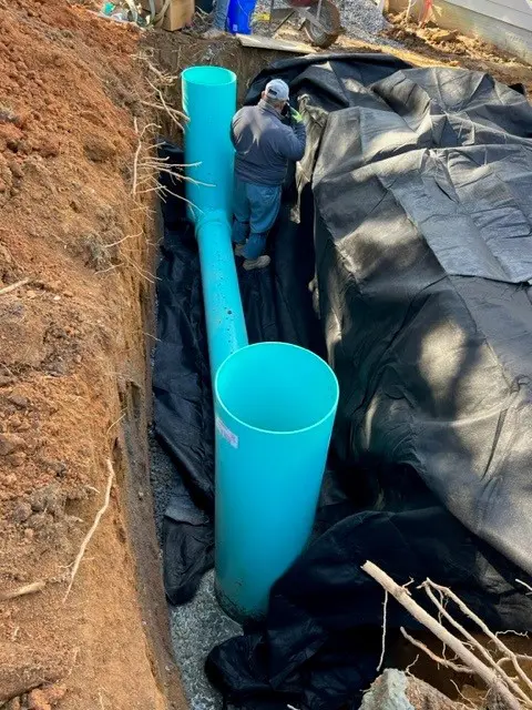 Worker talking for water management near a blue big pipe