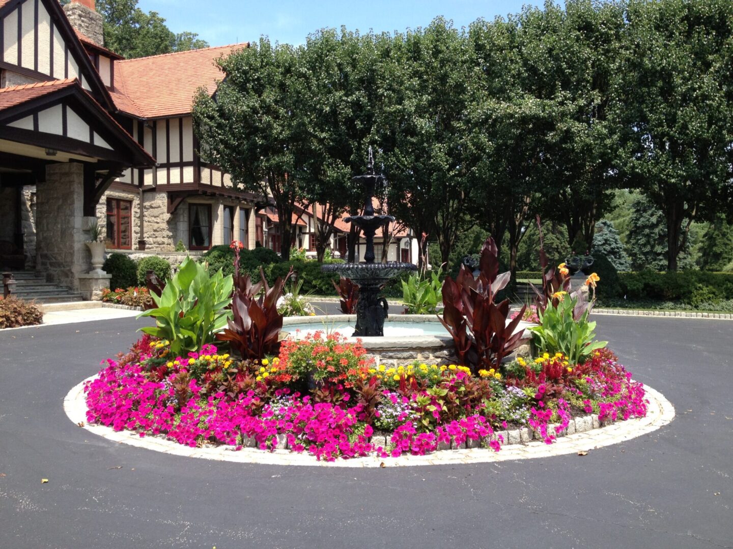 Colorful garden with fountain centerpiece.